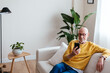 © BONNINSTUDIO/Stocksy - Relaxed aged man browsing smartphone at home