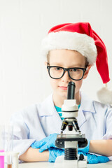 Wall Mural - student learning chemistry. positive joyful smart boy testing and using a microscope in science clas