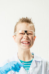Wall Mural - funny boy dressed as chemist with dirty face after a failed experiment