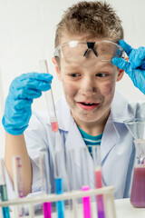 Wall Mural - funny boy dressed as chemist with dirty face after a failed experiment