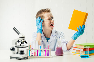 Wall Mural - funny boy dressed as chemist with dirty face after a failed experiment