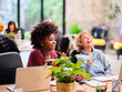© Guille Faingold/Stocksy - Businesswomen laughing at joke in office