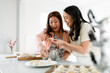 © McKinsey Jordan/Stocksy - Women Bond Over Making Dinner