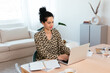 © BONNINSTUDIO/Stocksy - Positive freelancer using laptop at home