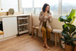 © BONNINSTUDIO/Stocksy - Young female having breakfast in kitchen