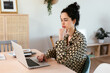 © BONNINSTUDIO/Stocksy - Thoughtful woman using laptop at home