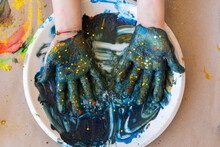 Top View Of Mixing Blue Paint With Gold Stars For Crafts