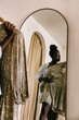 © VISUALSPECTRUM/Stocksy - Black Woman Shopping for Dress in Boutique