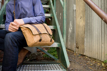 Seated Man With Leather Messenger Bag