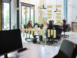 © Guille Faingold/Stocksy - Coworkers behind glass wall with Kanban board