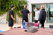 © Guille Faingold/Stocksy - Cheerful coach speaking with athletes outside gym