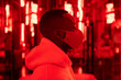 © VICTOR TORRES/Stocksy - Black man in mask in room with red illumination