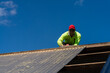 © Gillian Vann/Stocksy - tradie working on a roof