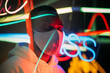 © VICTOR TORRES/Stocksy - Ethnic man in mask in room with neon illumination