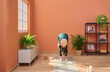 © Guille Faingold/Stocksy - Woman doing yoga in sunny living room