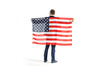 © A Stock Studio - Back view of a full height business man holding a USA flag, isolated on a white background.