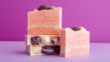 Handmade Pink Soap Bars Composition. Many Craft Artisan Diy Pink Soap Bars With Berries On Top On Purple Background. Natural Skin Care Beauty Bath Products, Homemade Toiletries. Long Web Banner