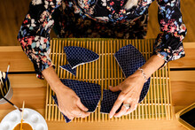 Top view of woman repairing a broken plate with gold