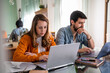 © Guaita Studio/Stocksy - Young couple working from home in living room