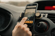 © Nuria Seguí/Stocksy - Close-Up Of Woman Using Delivery Application In Car.