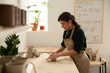 © Malquerida Studio/Stocksy - Ceramist young woman preparing clay to make pottery pieces in her studio