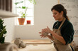 © Malquerida Studio/Stocksy - Ceramist young woman preparing clay to make pottery pieces in her studio
