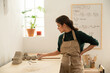 © Malquerida Studio/Stocksy - Ceramist young woman preparing clay to make pottery pieces in her studio