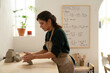 © Malquerida Studio/Stocksy - Ceramist young woman preparing clay to make pottery pieces in her studio
