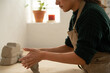 © Malquerida Studio/Stocksy - Ceramist young woman preparing clay to make pottery pieces in her studio