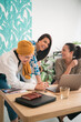 © Studio Marmellata/Stocksy - Cheerful women working together in modern office