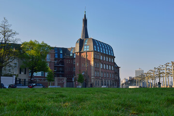 Wall Mural - View of the city embankment with a green lawn