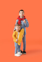 Poster - Cute little children with skateboard on color background