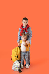 Poster - Cute little children with backpacks on color background