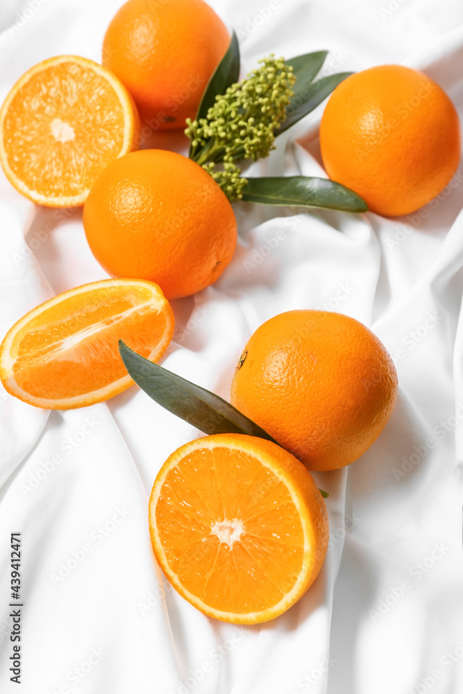 Juicy oranges on fabric background