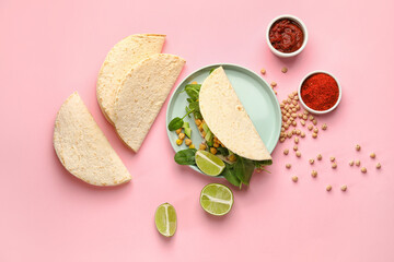 Plate with tasty vegetarian taco and sauce on color background