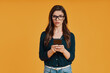 © gstockstudio - Beautiful young woman in casual clothing using smart phone