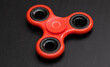 Red spinner on a black table close-up