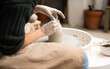 © Malquerida Studio/Stocksy - Close up of ceramist woman Making Clay Product With Pottery lathe in her studio