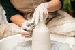 © Malquerida Studio/Stocksy - Close up of ceramist woman Making Clay Product With Pottery lathe in her studio