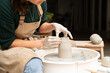 © Malquerida Studio/Stocksy - Close up of ceramist woman Making Clay Product With Pottery lathe in her studio