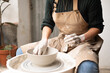 © Malquerida Studio/Stocksy - Close up of ceramist woman Making Clay bowl With Pottery lathe in her studio