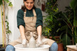 © Malquerida Studio/Stocksy - Ceramist young woman Making Clay Product With Pottery lathe in her studio