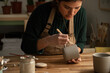 © Malquerida Studio/Stocksy - Ceramist young woman Making Clay cups  in her studio