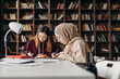 © Stereo Shot/Stocksy - Focused female students working on project in library