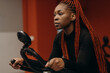 © Stereo Shot/Stocksy - African American sportswoman on exercise bike in gym