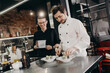 © Stereo Shot/Stocksy - Chef with apprentice preparing dish in restaurant