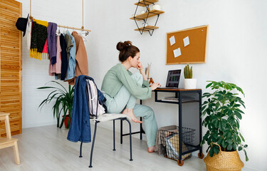 Stylish woman browsing laptop at home