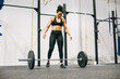 © Inuk Studio/Stocksy - Muscular female athlete preparing to lift barbell