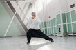 © Stereo Shot/Stocksy - Muslim sportswoman doing side lunge during training