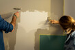 © Valentina Barreto/Stocksy - couple painting wall